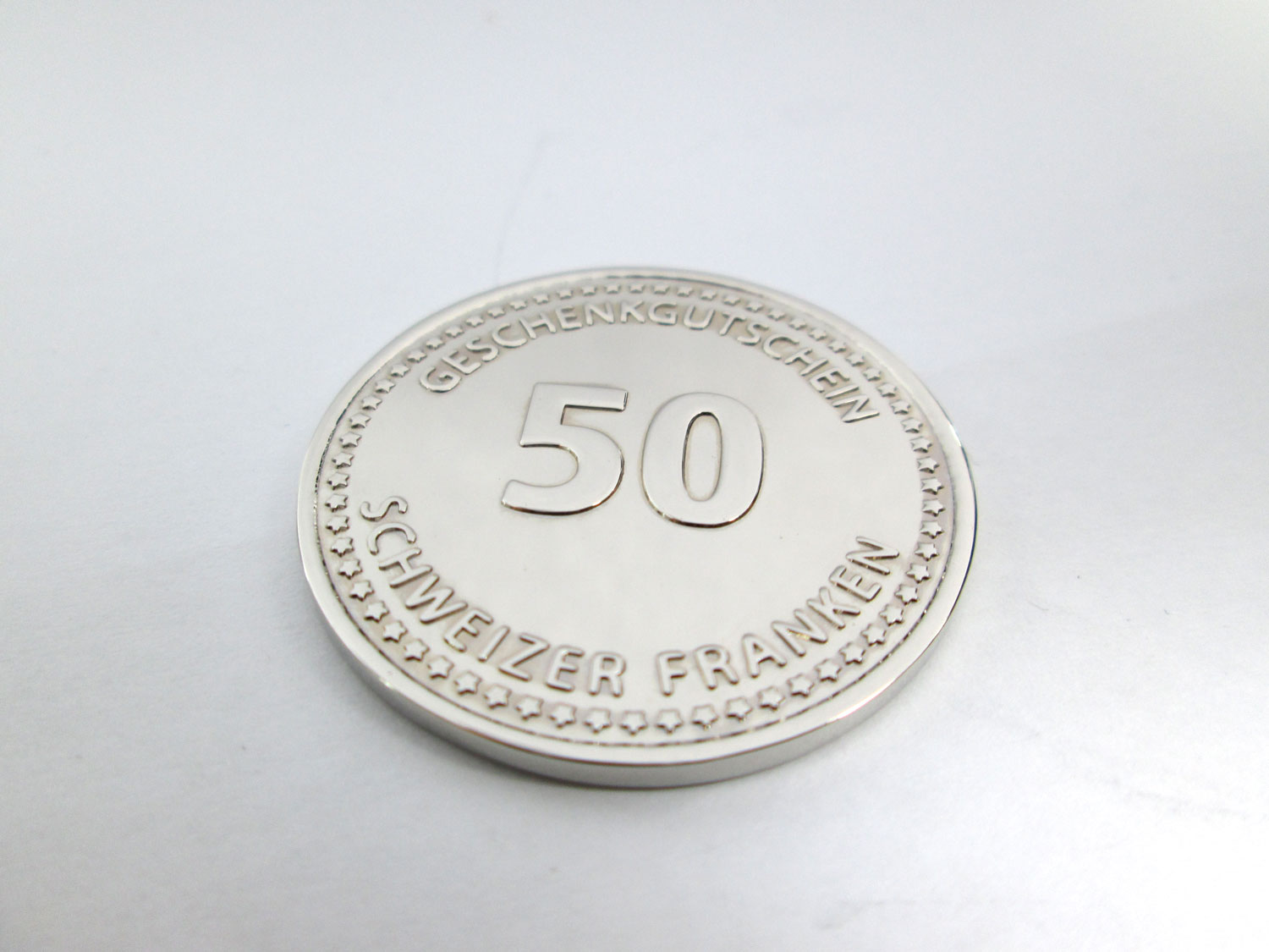 stamped coin used as a gift voucher for a swiss jeweler
